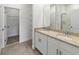Bathroom with double vanity, granite countertops, and walk-in shower at 1797 Archer Dr, Minneola, FL 34715