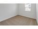 Cozy bedroom featuring neutral carpet and a bright window at 1797 Archer Dr, Minneola, FL 34715
