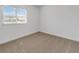 Simple bedroom offers neutral carpet and ample natural light at 1797 Archer Dr, Minneola, FL 34715