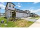 Exterior of a townhome with two-car garage and landscaped front yard at 1797 Archer Dr, Minneola, FL 34715
