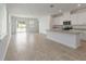 Bright open-concept kitchen and living space with tiled floors and ample natural light at 1797 Archer Dr, Minneola, FL 34715