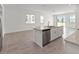 Kitchen with island, stainless steel appliances, and open to the living area at 1797 Archer Dr, Minneola, FL 34715