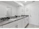 Bright bathroom features double vanity, granite counters, and white cabinets at 1809 Tropical Palms Cir, Kissimmee, FL 34747