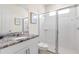 Modern bathroom featuring granite countertops, a glass-enclosed shower, and neutral tones at 1809 Tropical Palms Cir, Kissimmee, FL 34747