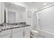 Well-lit bathroom with granite vanity, white cabinets, and shower-tub combination at 1809 Tropical Palms Cir, Kissimmee, FL 34747