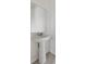 Bathroom sink features a pedestal sink, mirror, and modern faucet at 1809 Tropical Palms Cir, Kissimmee, FL 34747