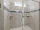 Modern bathroom with glass-enclosed shower, neutral tile, and built-in shelving at 1809 Tropical Palms Cir, Kissimmee, FL 34747