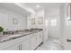 Bright bathroom features double sinks, granite countertops, and modern fixtures at 1809 Tropical Palms Cir, Kissimmee, FL 34747