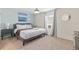 Bright bedroom featuring a queen bed, modern lighting, and scenic wall art at 1809 Tropical Palms Cir, Kissimmee, FL 34747