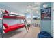 Fun bedroom featuring a bunk bed, modern lighting, and a super hero themed wall art at 1809 Tropical Palms Cir, Kissimmee, FL 34747