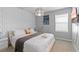 Comfortable bedroom featuring a queen bed, modern lighting, and decorative wall accents at 1809 Tropical Palms Cir, Kissimmee, FL 34747