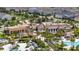 Aerial view of community clubhouse, featuring lush landscaping, pool, and seating at 1809 Tropical Palms Cir, Kissimmee, FL 34747