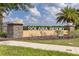Solara Resort entrance with stone pillars, landscaping, and clear signage against a blue sky at 1809 Tropical Palms Cir, Kissimmee, FL 34747