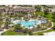 Aerial view of community pool area featuring cabanas, lush landscaping, and ample seating at 1809 Tropical Palms Cir, Kissimmee, FL 34747