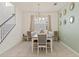 Bright dining room with modern chandelier, neutral decor, and easy access to the staircase at 1809 Tropical Palms Cir, Kissimmee, FL 34747