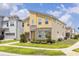 Charming two-story home with a stone facade, lush landscaping, and a corner lot at 1809 Tropical Palms Cir, Kissimmee, FL 34747