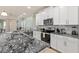Updated kitchen featuring an island with seating, stainless appliances, and granite counters at 1809 Tropical Palms Cir, Kissimmee, FL 34747