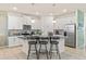 Modern kitchen with white cabinets, granite countertops, stainless steel appliances, and a breakfast bar at 1809 Tropical Palms Cir, Kissimmee, FL 34747