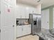 Spacious kitchen with stainless steel refrigerator and ample white cabinet storage at 1809 Tropical Palms Cir, Kissimmee, FL 34747