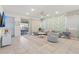 Bright living room with tile flooring, a decorative wall, and a sliding door to the outdoor space at 1809 Tropical Palms Cir, Kissimmee, FL 34747