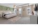Spacious main bedroom with a king bed, decorative wall vines, and plenty of natural light at 1809 Tropical Palms Cir, Kissimmee, FL 34747