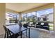 Screened-in patio features dining table and outdoor seating at 1809 Tropical Palms Cir, Kissimmee, FL 34747