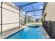 Sparkling screened-in pool and spa with brick paver surround at 1809 Tropical Palms Cir, Kissimmee, FL 34747
