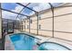Screened-in pool and spa with brick paver surround at 1809 Tropical Palms Cir, Kissimmee, FL 34747