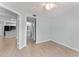 Spacious bedroom with wood-look flooring and neutral paint near kitchen and bathroom at 1908 Lake Atriums Cir # 3, Orlando, FL 32839