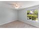 Light and airy bedroom featuring neutral paint, wood-look flooring, and a ceiling fan at 1908 Lake Atriums Cir # 3, Orlando, FL 32839