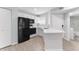 Compact kitchen featuring sleek black appliances and white cabinetry at 1908 Lake Atriums Cir # 3, Orlando, FL 32839