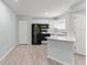 Efficient kitchen with white cabinets, black appliances, and modern countertops at 1908 Lake Atriums Cir # 3, Orlando, FL 32839