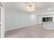 Open-concept living room and kitchen with wood-look tile and ample natural light at 1908 Lake Atriums Cir # 3, Orlando, FL 32839