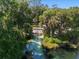 Scenic waterfront property featuring a river leading to a private dock and lush greenery at 19430 Sw 100Th Loop, Dunnellon, FL 34432