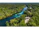 Gorgeous aerial view of a winding river surrounded by lush green forests at 19430 Sw 100Th Loop, Dunnellon, FL 34432
