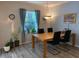 Inviting dining room with natural light, stylish furniture, and wood flooring at 19430 Sw 100Th Loop, Dunnellon, FL 34432