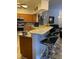 Open kitchen featuring counter seating and stainless steel appliances perfect for entertaining at 19430 Sw 100Th Loop, Dunnellon, FL 34432