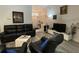 Comfortable living room with hardwood flooring, leather furniture, and ample natural light at 19430 Sw 100Th Loop, Dunnellon, FL 34432