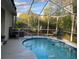 Refreshing screened-in pool with a covered patio area, perfect for outdoor relaxation and entertainment at 19430 Sw 100Th Loop, Dunnellon, FL 34432