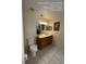 Cozy bathroom featuring a vanity with ample storage, neutral tile flooring, and a standard toilet at 226 Canna Dr, Davenport, FL 33897