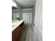 Well-lit bathroom with a double vanity and combination shower and tub at 226 Canna Dr, Davenport, FL 33897