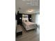 Modern bedroom boasts dark accent wall, a cushioned bench, and bright natural light at 226 Canna Dr, Davenport, FL 33897