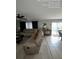 Bright and airy living room that connects to a pool with a neutral-toned sectional and console table at 226 Canna Dr, Davenport, FL 33897