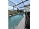 Screened-in pool area with a clean, blue pool and views of the backyard and surrounding homes at 226 Canna Dr, Davenport, FL 33897