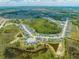 Expansive aerial view of a Primary-planned community with lush greenery and picturesque lakes dotting the landscape at 236 Miles Ct, Davenport, FL 33837