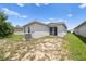 The backyard features a sliding glass door and some grass, perfect for outdoor relaxation and entertaining at 236 Miles Ct, Davenport, FL 33837