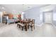 Open dining area adjacent to kitchen, featuring a wooden table, ample seating, and a bright, airy atmosphere at 236 Miles Ct, Davenport, FL 33837