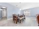 Inviting dining room with vaulted ceiling, a large wooden table, and plenty of natural light at 236 Miles Ct, Davenport, FL 33837