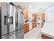 Well-lit kitchen featuring stainless steel appliances, ample cabinet space, and modern tile flooring at 236 Miles Ct, Davenport, FL 33837