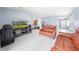 Spacious open-concept living area featuring tile flooring and a comfortable seating arrangement for relaxation and entertainment at 236 Miles Ct, Davenport, FL 33837
